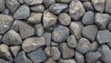 Broken river stones display unique shapes, exposing their smooth interiors, ideal for rugged landscape design and construction