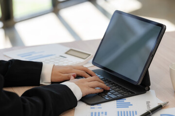Close-up hand of an Asian businesswoman typing on a keyboard.