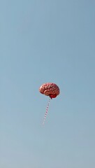 Brain Balloon Ascending in a Clear Sky
