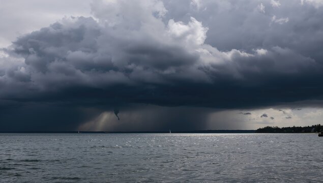 Dark storm clouds gathering above a large freshwater lake