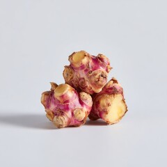 Stacked Colorful Root Vegetables Against Light Gray Background