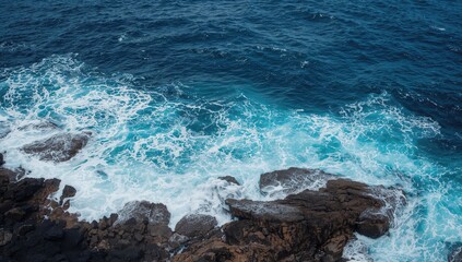 Mighty sea swells slam into jagged lava formations, crafting a striking shoreline panorama.