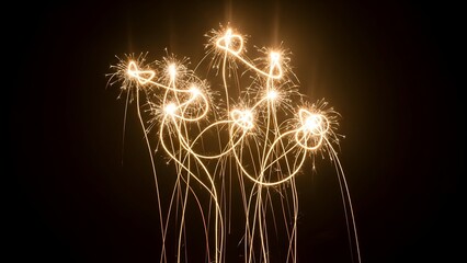 Artistic depiction of light trails resembling flowers against a dark background, evoking a sense of celebration
