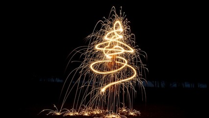 Glowing light trails form a spiraling tree shape against a dark night