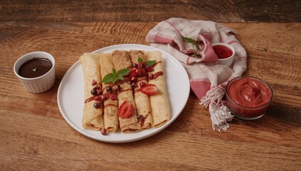 Crepes presented with a selection of sauces on a wooden surface, fiber-dense choice