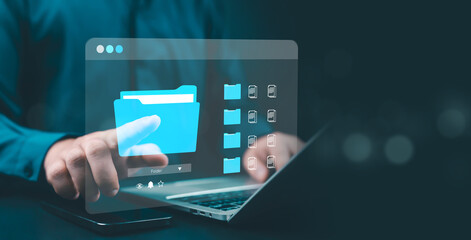 Businessman using laptop with digital folder interface, symbolizing cloud storage, data management, and document organization technology in modern digital workspace.