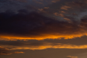 Fiery orange clouds illuminated by sunset light