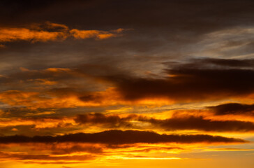 Fiery orange clouds illuminated by sunset light