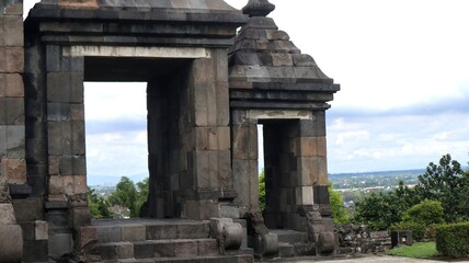 Ancient natural stone gate. Traditional split gate in the garden. Beautiful antique stone carved split gate