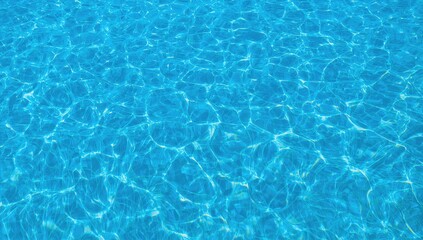 Obraz premium The calm blue and turquoise water surface under a sunny sky, showcasing gentle wave patterns and a silky texture.