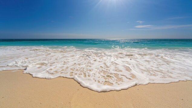 Ocean waves gently washing over sandy shore in summer