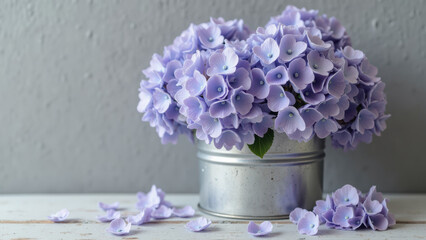 Obraz premium Beautiful purple flowers in silver metal pot, creating serene and calming atmosphere. delicate petals and soft colors enhance aesthetic appeal