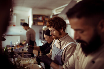 Chefs preparing food in restaurant kitchen