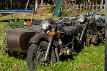 Abandoned Vintage Motorcycles in Overgrown Yard