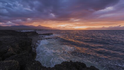 Obraz premium Dawn breaking ahead of a tempest in a volcanic island setting