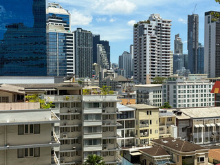 Modern skyline view with mix of residential and commercial buildings under bright sunny sky