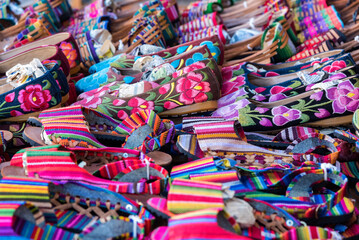 View of an exhibition of handcrafted Mexican shoes in full color, sandals