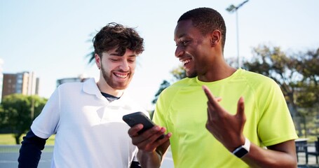 Men, friends and phone at tennis court, laugh and talk on break with meme at fitness club. People, happy and athlete on smartphone, mobile app and chat for tips, guide or tutorial video for training