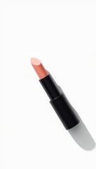 Obraz premium Elegant coral-hued lipstick with sleek black case against a pristine white background, casting a subtle shadow with a hint of minimalistic glamour