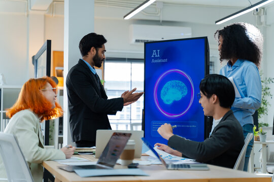 Diverse creative team use Ai Assistant (artificial intelligence assistant) on AI-assisted display for Marketing Data Analyst meeting at office.Coding team,develop Ai Assistant,business brainstorming