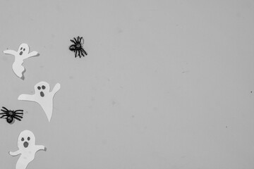 Halloween double frame with black and white theme of scattered candy and decorations. Flat background with copy space.