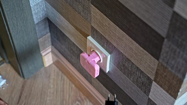 Person plugging extension adapter into wall socket and connecting two chargers. Electricity and daily usage concept.