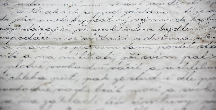 Close up of old handwritten Czech document showing part of a vintage land purchase contract about establishing a right of habitation, aged paper with calligraphic ink writing, no personal data