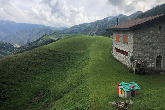 Ancient Stone Mountain House with Beautiful View on Valle del Riso, in the Italian Alps, During a Cloudy Summer Day. Bergamo Province, Italy