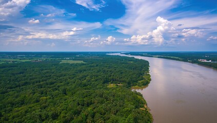 Aerial view of a river flowing through lush green forests and a harbor, highlighting natural beauty and accessibility