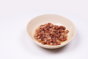 Wet cat food with jelly in a ceramic feeding bowl