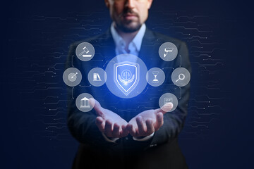 Man in suit holds glowing shield with legal icons in hands, representing protection and justice