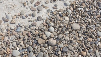 Smooth ocean stones and colorful rocks on the shore, natural abstract stone texture background.