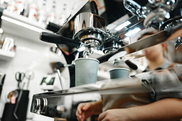 Barista prepares espresso in a cozy coffee shop during a busy afternoon