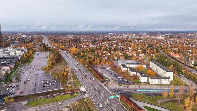 E4 motorway from Stockholm towards Uppsala, near Kista, aerial view, with autumn colors and the sprawling suburbs of the city, Sweden