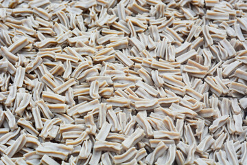 Pile of colorful raw crackers on a white background