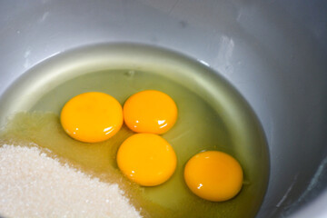A selection of baking ingredients displayed with milk, flour, and eggs for cake or bread making