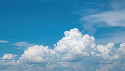 A serene blue sky featuring fluffy white cumulus clouds, ideal for background use