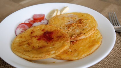 Traditional corn pancakes crafted from fresh tender corn.