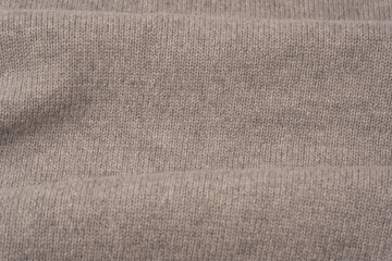 Soft grey merino wool sweater texture as a background.