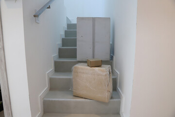
Packages and closed moving boxes on a building staircase