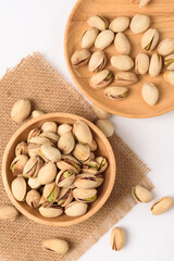 Roasted pistachios with salt, healthy snack on white background