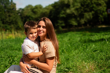 Fototapeta premium Joyful moment of happy mother spending time with her kid. Laughing, kissing, hugging, tickling. Parenthood moment.
