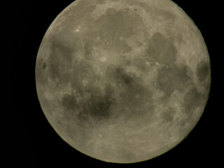 Detailed full moon surface with craters and maria against deep black space background.