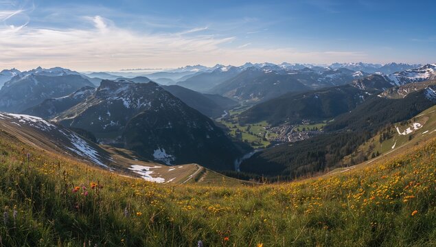 Aerial view of snow-laden Alps in a mountainous region, showcasing seasonal change