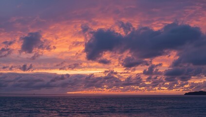 Dramatic clouds over ocean at winter dusk, showcasing seasonal change