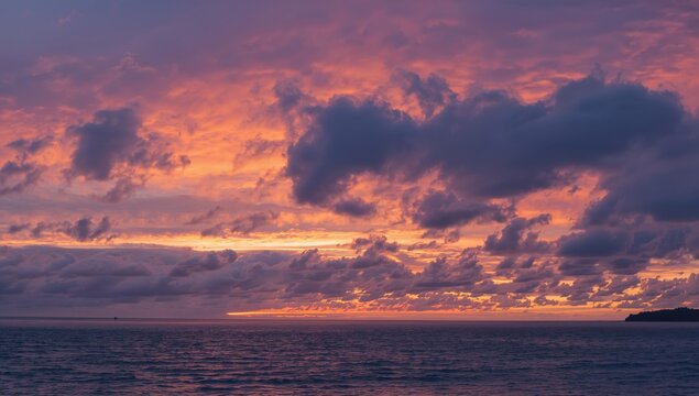Dramatic clouds over ocean at winter dusk, showcasing seasonal change
