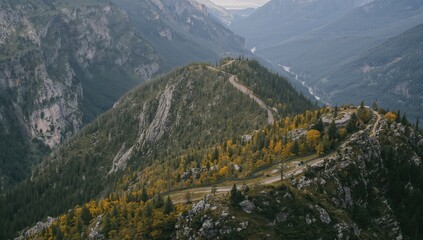 Naklejka premium Captured from an elevated position overlooking rugged, forested mountains with winding paths