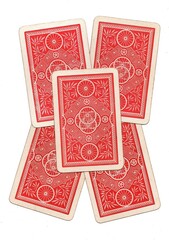 Fototapeta premium A hand of vintage playing card backs isolated on a white background.