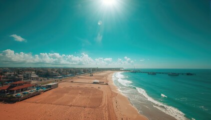 Aerial view of buildings lining a scenic coastline under a clear blue sky