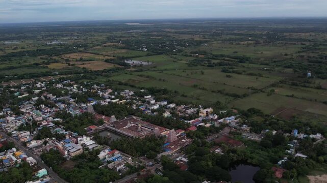 4K aerial drone video of Vaitheeswaran Koil temple and town in Tamil Nadu, India, showing historic architecture, lush green landscape, and peaceful village surroundings.